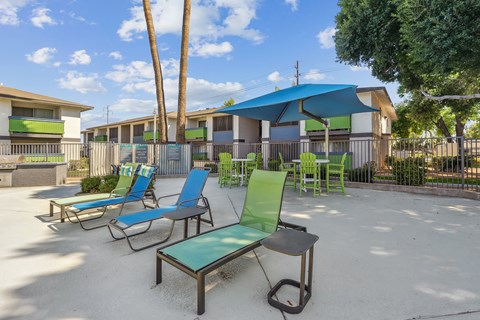 our apartments have a patio with chairs and umbrellas